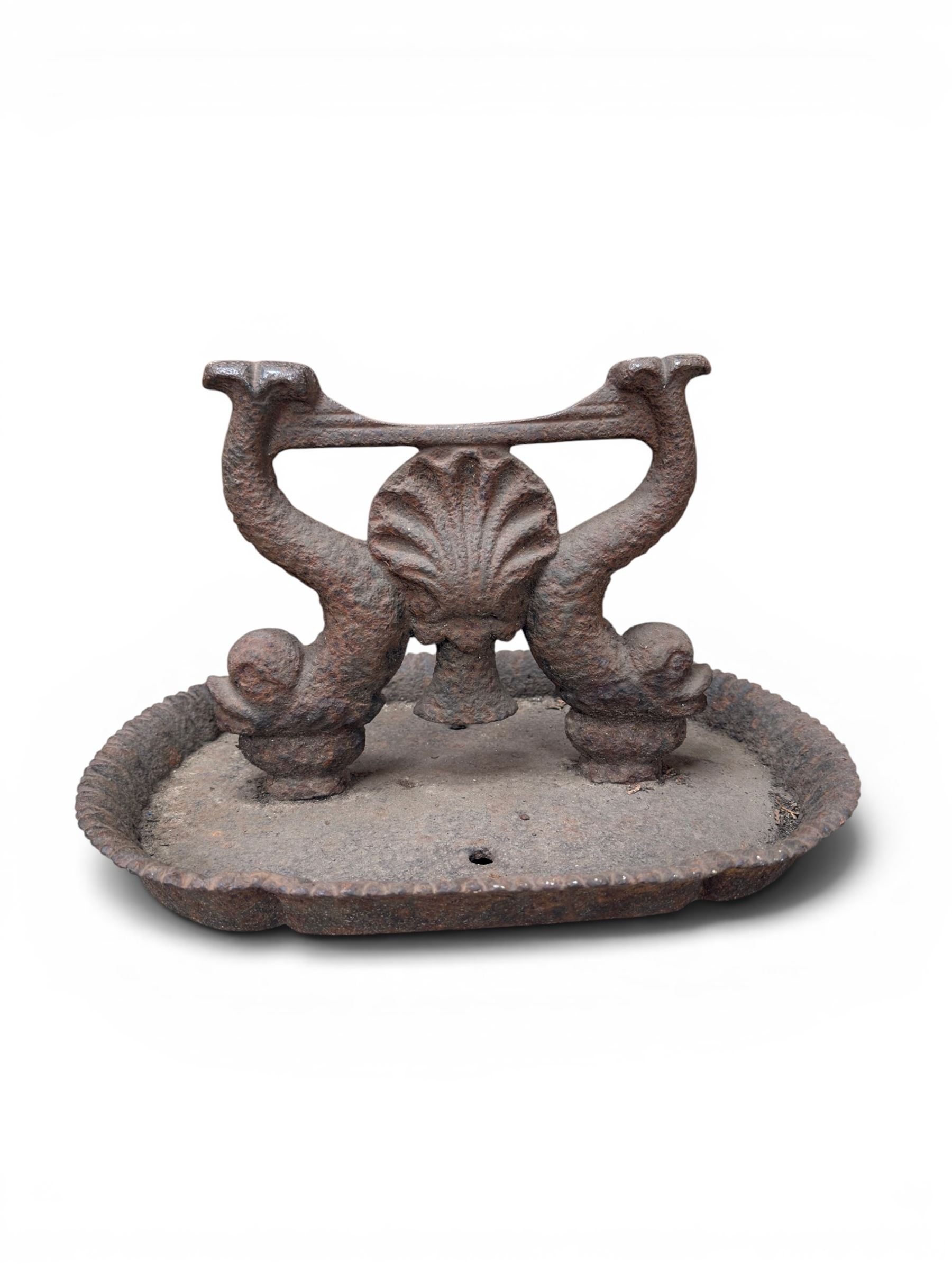 Victorian cast iron boot scraper, supported by two dolphins with central shell motif