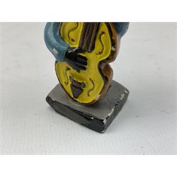 Robinson Jam plaster Golly band, including drummer and singer, H7.5cm

Originally handmade by mothers in Africa for their children from old fabric and cloth, the golly doll was adopted as the mascot and trademark for the Robertson's confectionery brand around 1910 after the company's founder John Robertson visited the US and noticed children playing with them. Robertson's Gollies have been collected by people across the UK and around the world for generations but garnered a contentious image in the 1980s because of links to racism. The trademark was removed from Robertson's branding in 2001.