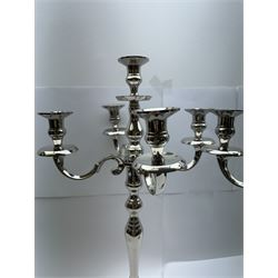 Pair of four branch candelabras, urn-shaped nozzles raised upon scroll branches supported from tapering central stem, with a stepped circular base, H59cm