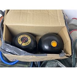 Five sets of bowling balls, four with bags