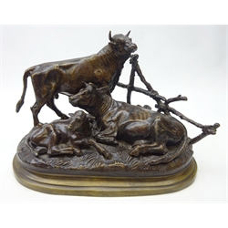  After Jules Moigniez (French, 1835-1894) Bronzed group of a bull, cow and calf, by a fence, on oval base, signed J Moigiez, L30cm   