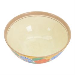 1930s Clarice Cliff Bizarre for Newport Pottery bowl, decorated in the Canterbury Bells pattern, the exterior painted with stylised flowers in blue, yellow and orange amongst foliage upon a brown and yellow Cafe au Lait stippled ground, with black printed mark beneath, D18cm