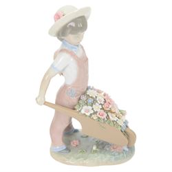 Three Lladro figures, comprising Spring Awakening 1283, Flower Harmony 1418 and Dutch girl with Tulips 5065
