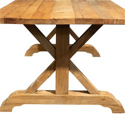 Pine country x-framed dining table, a rustic plank top raised on two x-framed supports