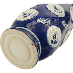 Chinses twin handled blue and white vase, decorated in relief with dragons amongst clouds upon a blue ground, H58cm 