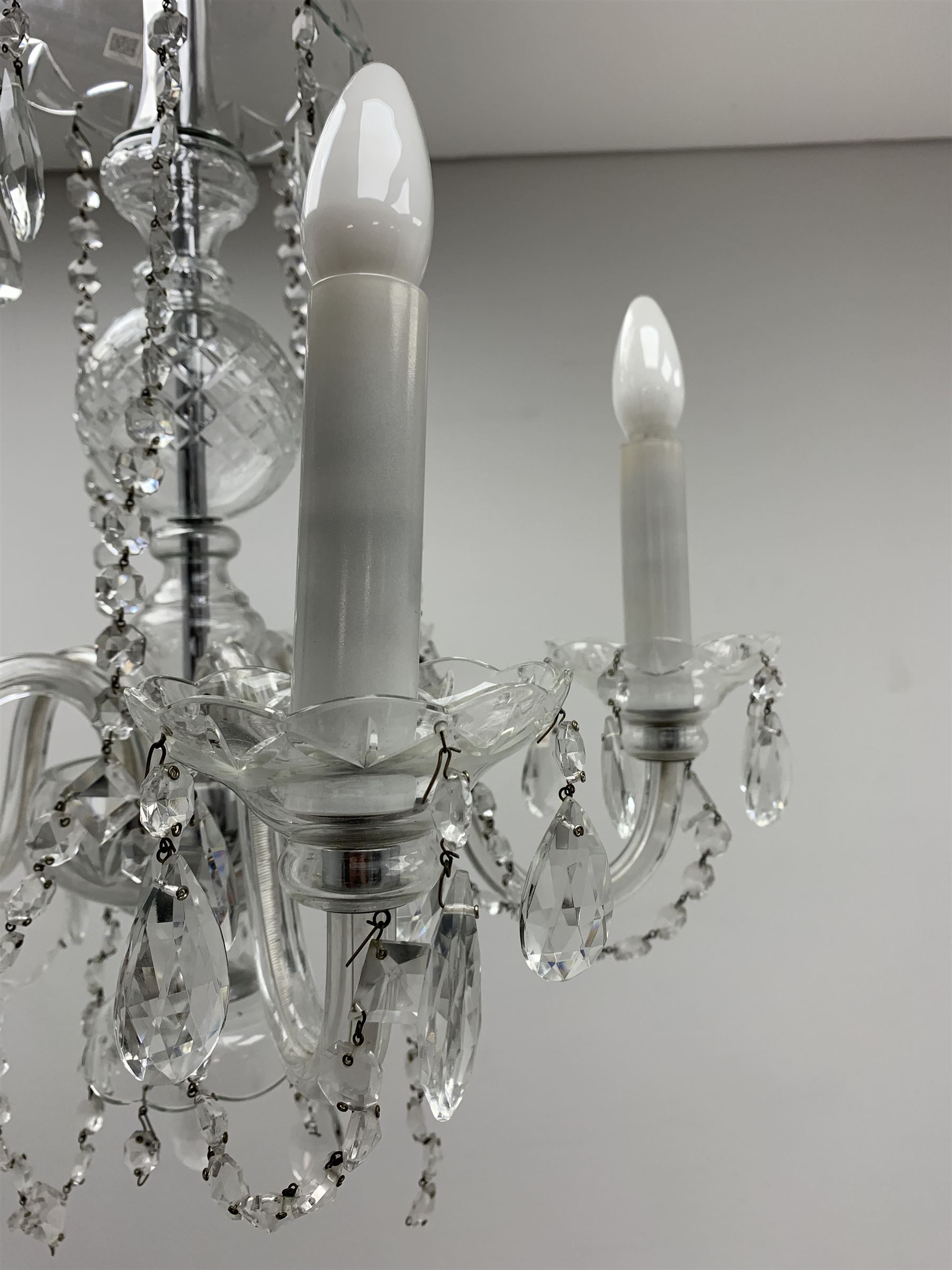 A glass chandelier, with five curved branches with drip pans and droppers, approximately H69cm. 