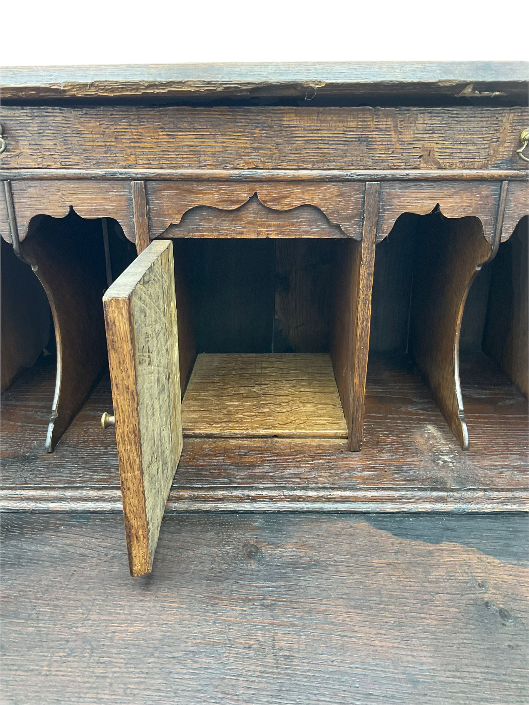 Georgian oak bureau, fall front enclosing fitted interior, four long graduating drawers, on bracket feet