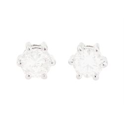 Pair of 18ct white gold diamond earrings, each stud six claw set with a round brilliant cu...