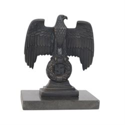 Composite cast bust of Hitler, together Third Reich Nazi German style desk stand depicting the national eagle and swastika on a black stone base, together with two other figures, bust H17cm 
