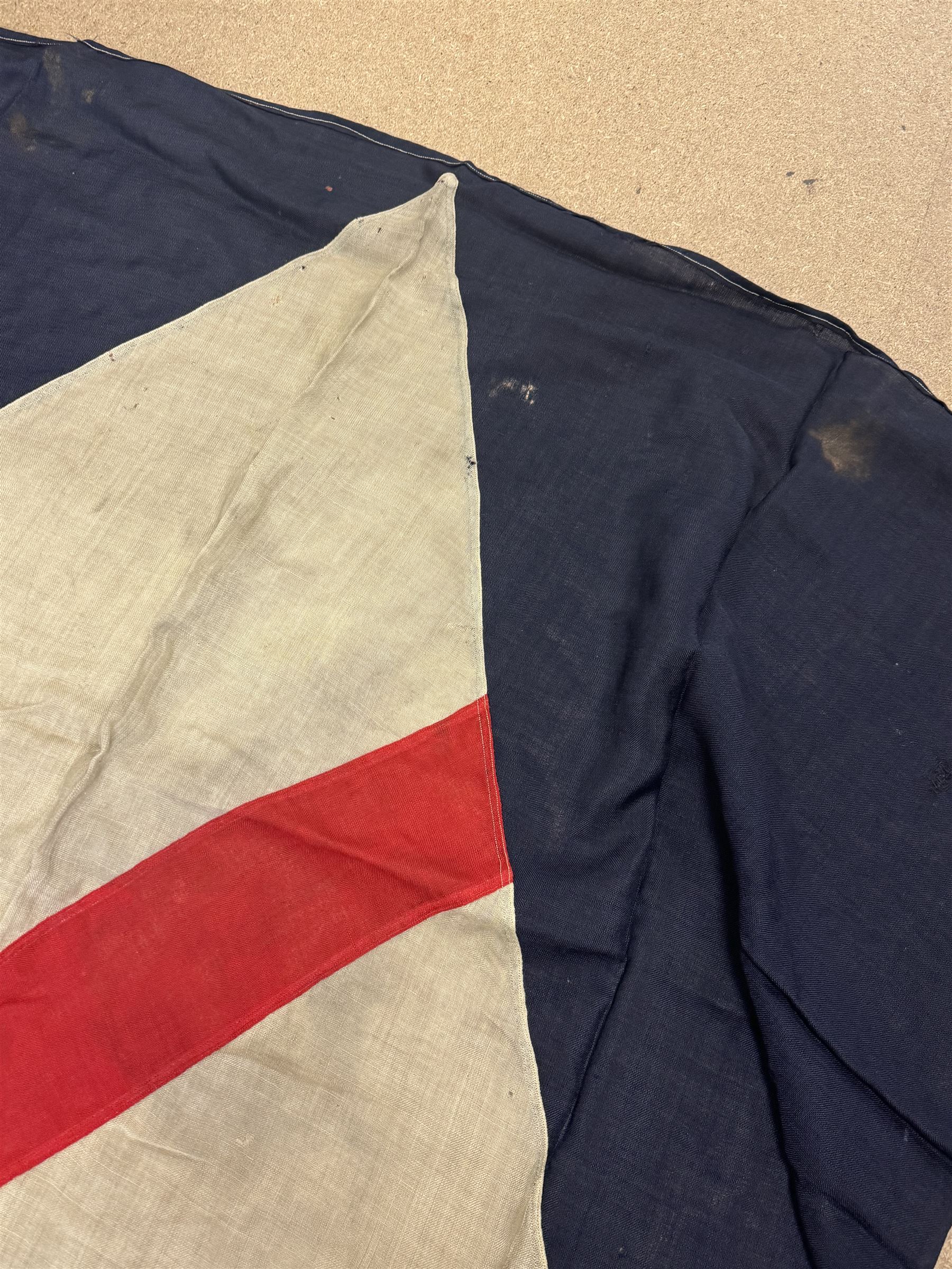 Ship's house flag, rectangular linen flag, with a white diamond and red cross to the centre, upon a cobalt blue ground, inscribed on the hoist 'Cutty Sark', H130cm, W170cm

Provenance by vendor repute: Vendor's father was a naval cadet in 1940s/50s on board HMS Worcester which was moored alongside the Cutty Sark on the River Thames at Greenhithe. He has had the flag since then. 