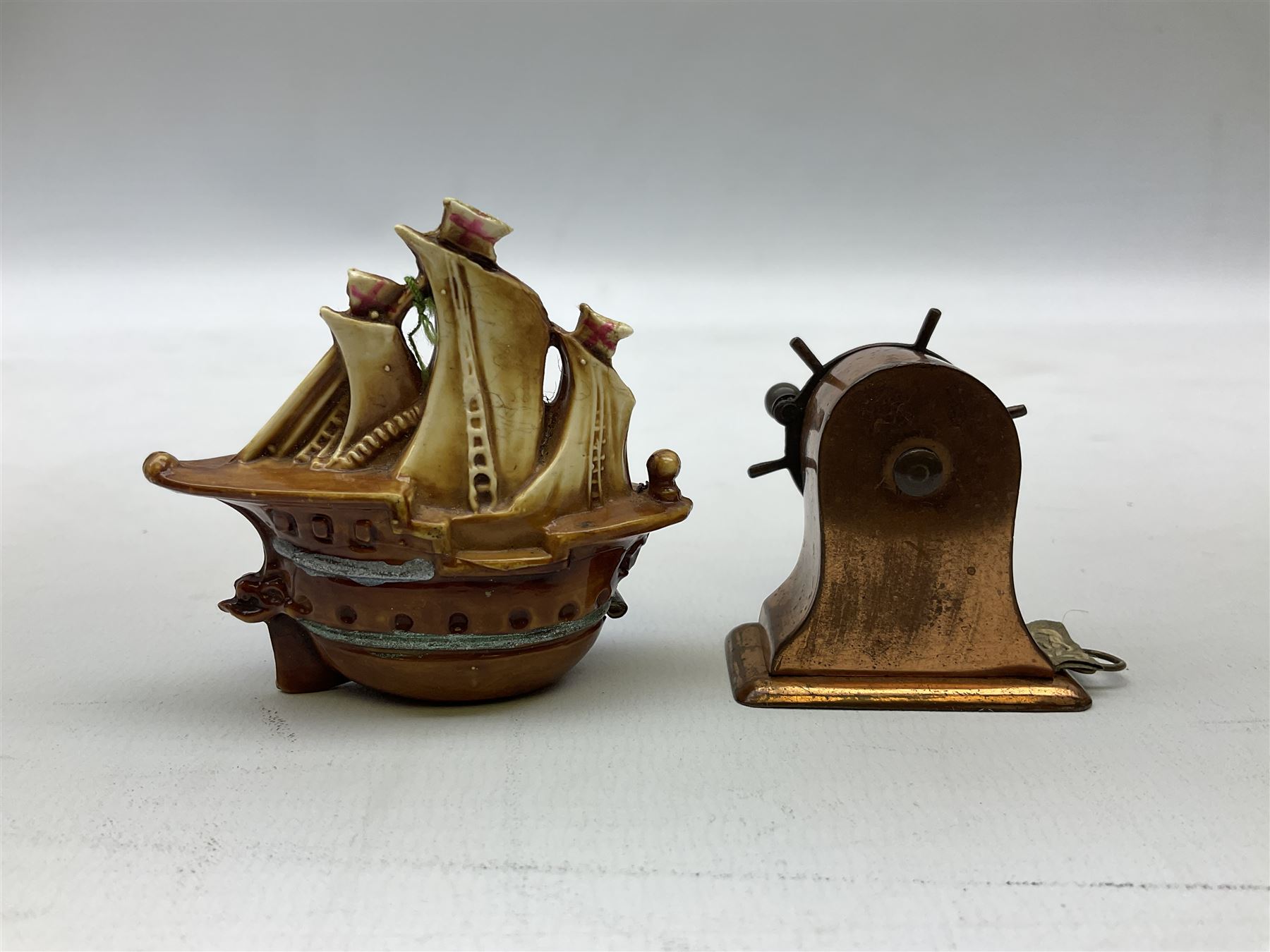 Copper tape measure in the form of a ship`s wheel, marked 'Rd. 128885' to the front, and a celluloid tape measure in the form of a galleon, wheel H4cm