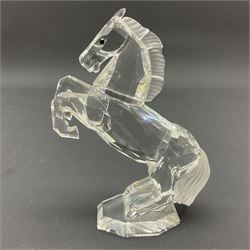 Five Swarovski Crystal horses, comprising stallion, rearing horse, pair of horses playing and Arabian stallion, each with frosted manes and tails, together with a small Swarovski Crystal galloping horse, the mane, tail and base with smoky tint