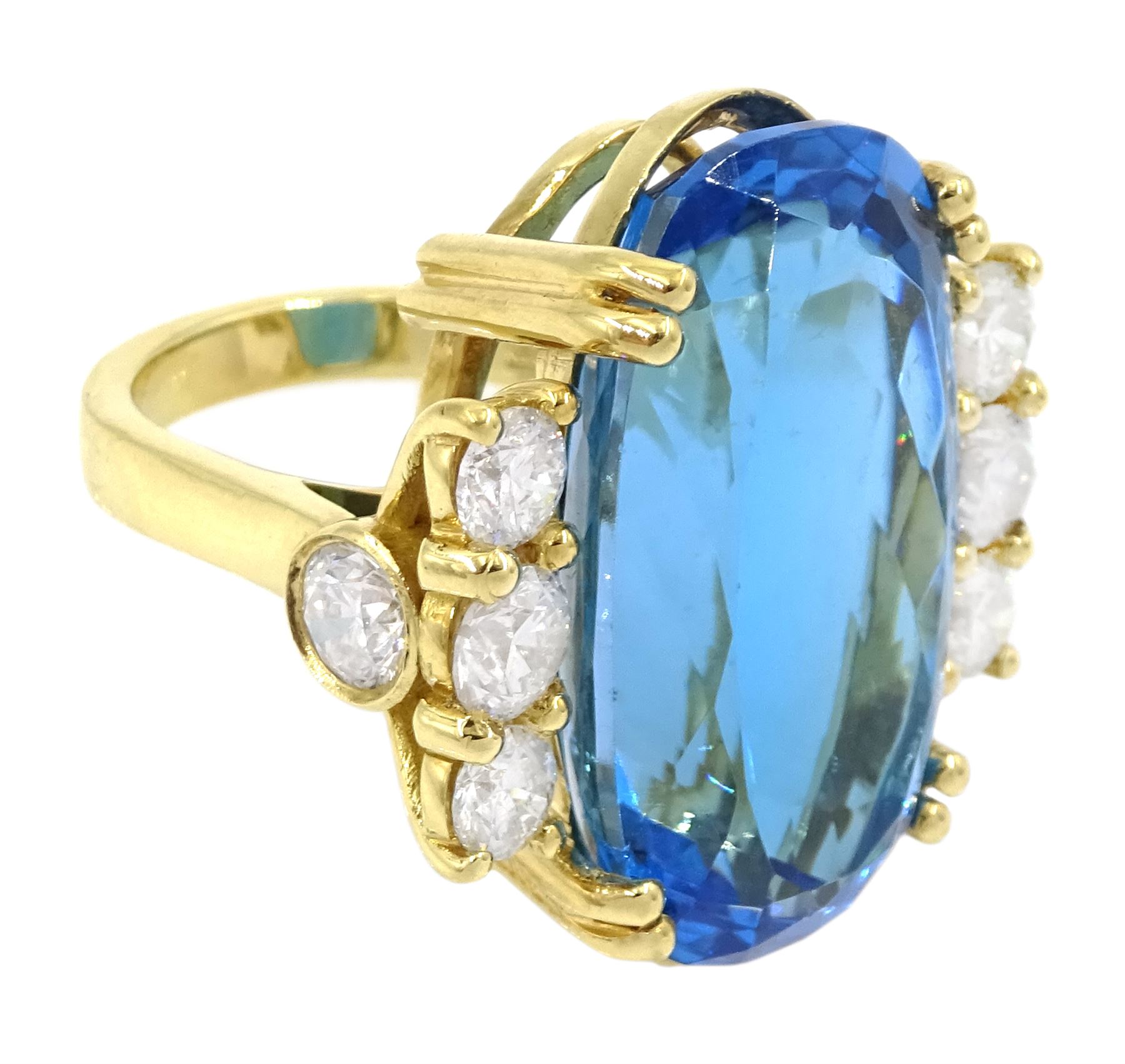 18ct gold blue topaz and diamond ring, single oval cut blue topaz of approx 31.10 carat, with four round brilliant cut diamonds set either side and a further two diamond set to the gallery, London 2019, total diamond weight approx 2.25 carat