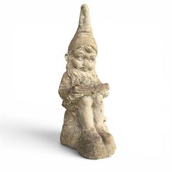 Two seated cast stone garden gnomes