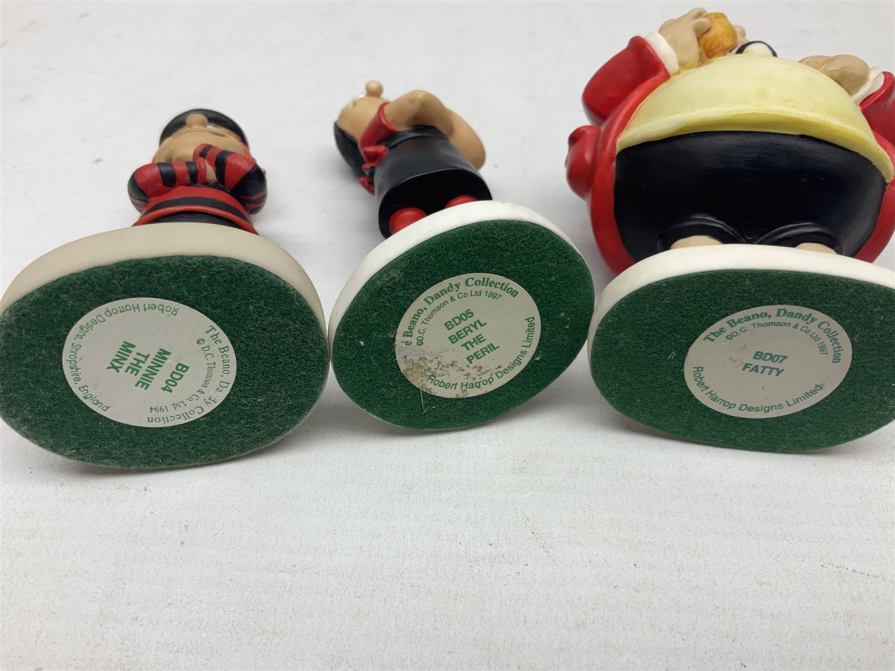 Eleven Robert Harrop figures from the Beano Dandy collection, comprising One Man & His Dawg BDS08, Picnic Desperate Dan BDS04, Fatty BD07, Desperate Dan BD03, Roger the Dodger BD20, Dennis the Menace BD01, Beryl the Peril BD05, Minnie the Minx BD04, Surfing BP03, two Spotty BD16, together with a Genuine Beano Ware lidded box (12)