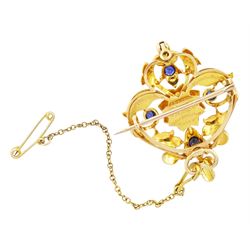 Victorian 15ct gold sapphire and split pearl pendant / brooch, the central flower head cluster set with a round cut sapphire surrounded by pearls, amongst an openwork setting set with four further sapphires and pearls, the reverse with presentation engraving and detachable brooch setting