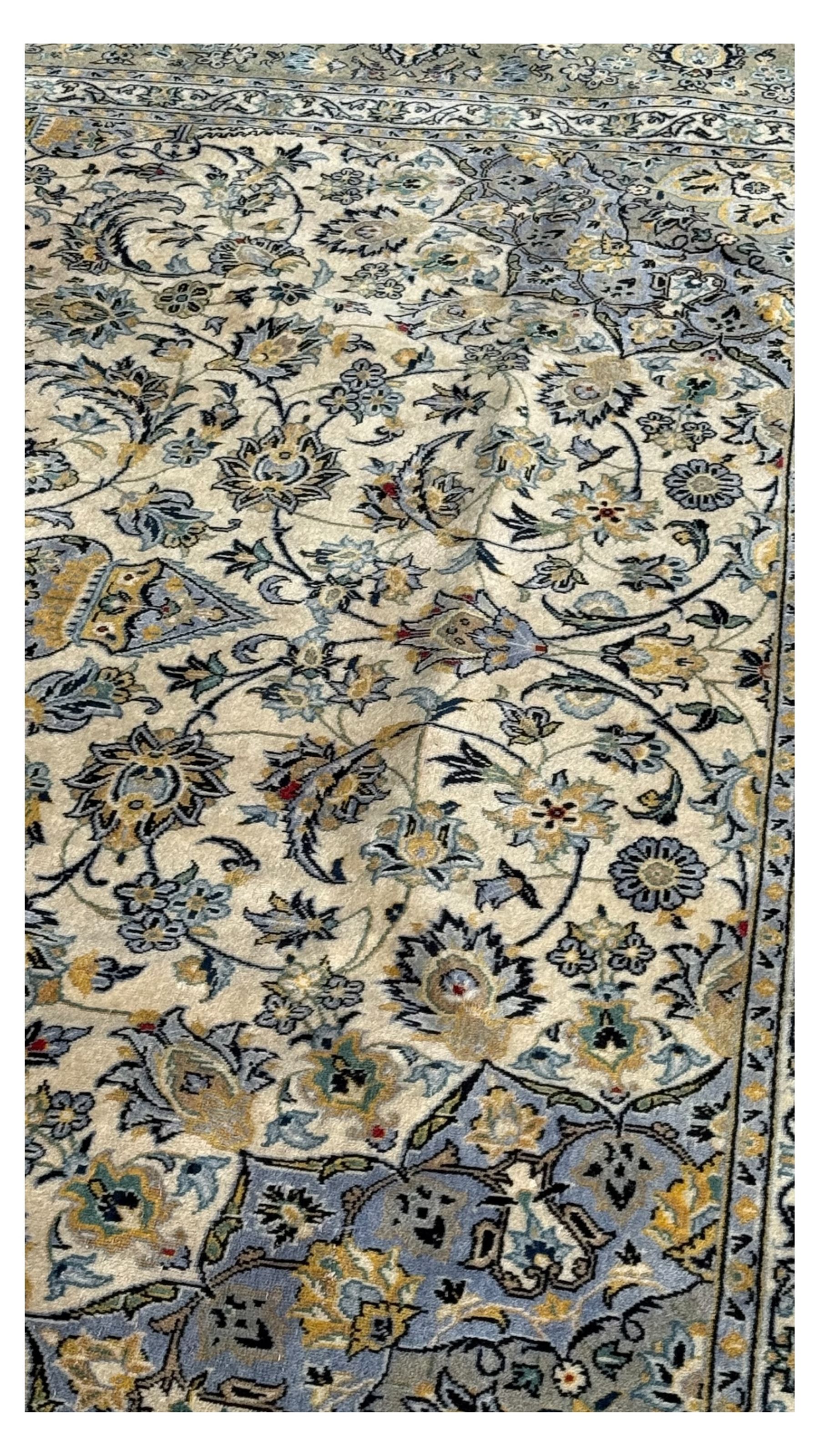 Kashan Persian rug, hand knotted, ivory ground rug, the rosette medallion decorated with projecting palmettes, on a field of swirling leafy branches and decorated with further palmettes, the scrolling border with repeating stylised plant motifs, within floral pattern guard stripes