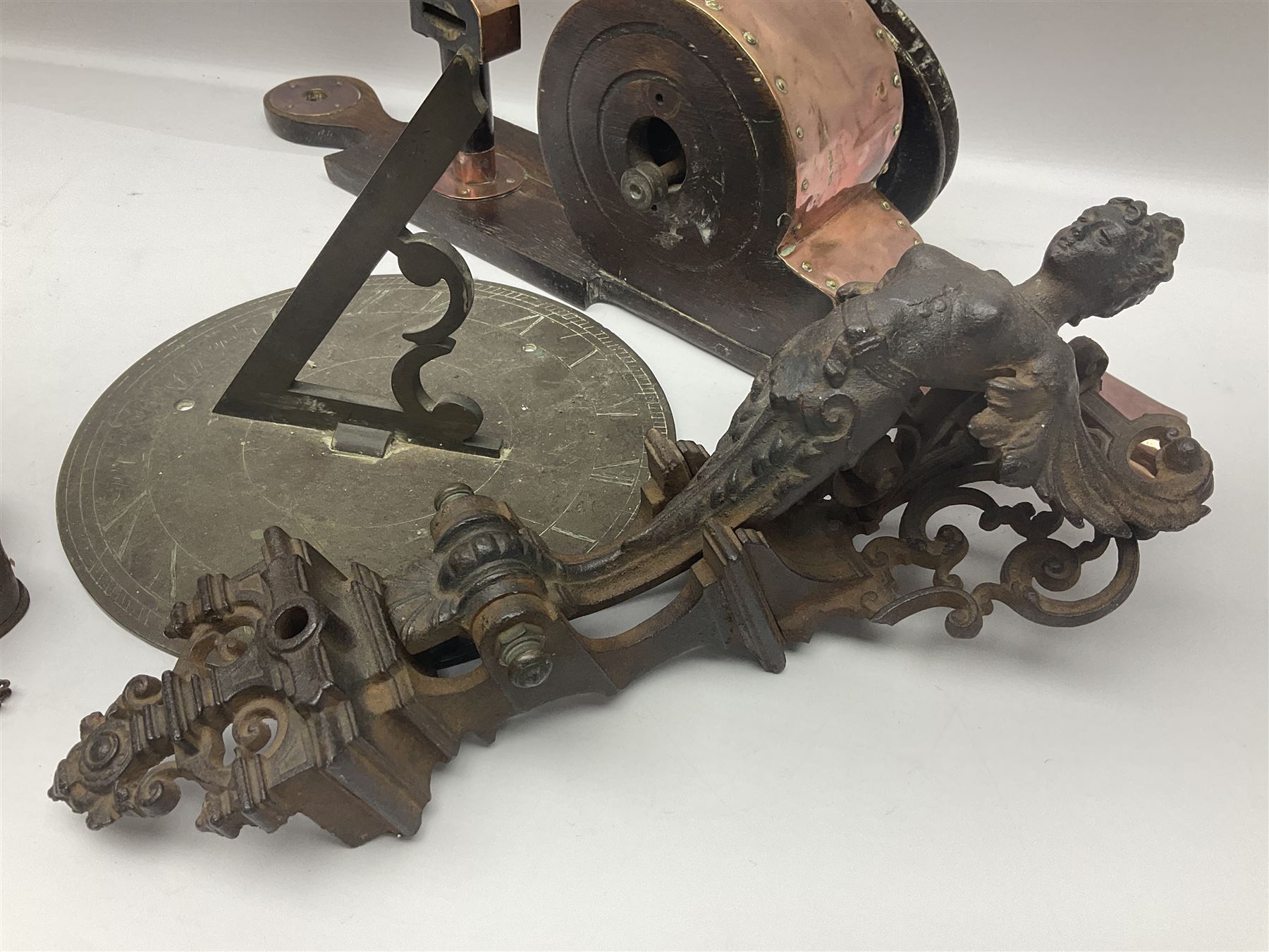 Two 19th century copper tankards, one with weighted wooden base, together with copper and wooden mechanical bellows, sundial and other metalware 