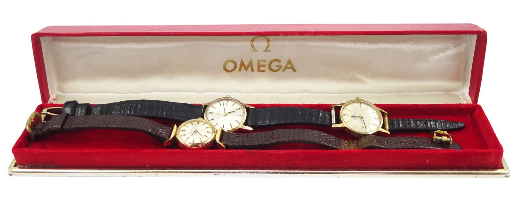 Two Omega ladies 9ct gold manual wind wristwatches, on on black leather strap and an Omega gold-plated manual wind wristwatch, on brown leather strap