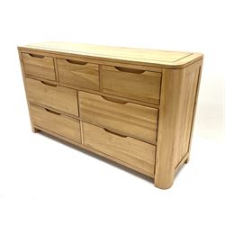 Light oak chest fitted with three short drawers above four long drawers, raised on stile supports 