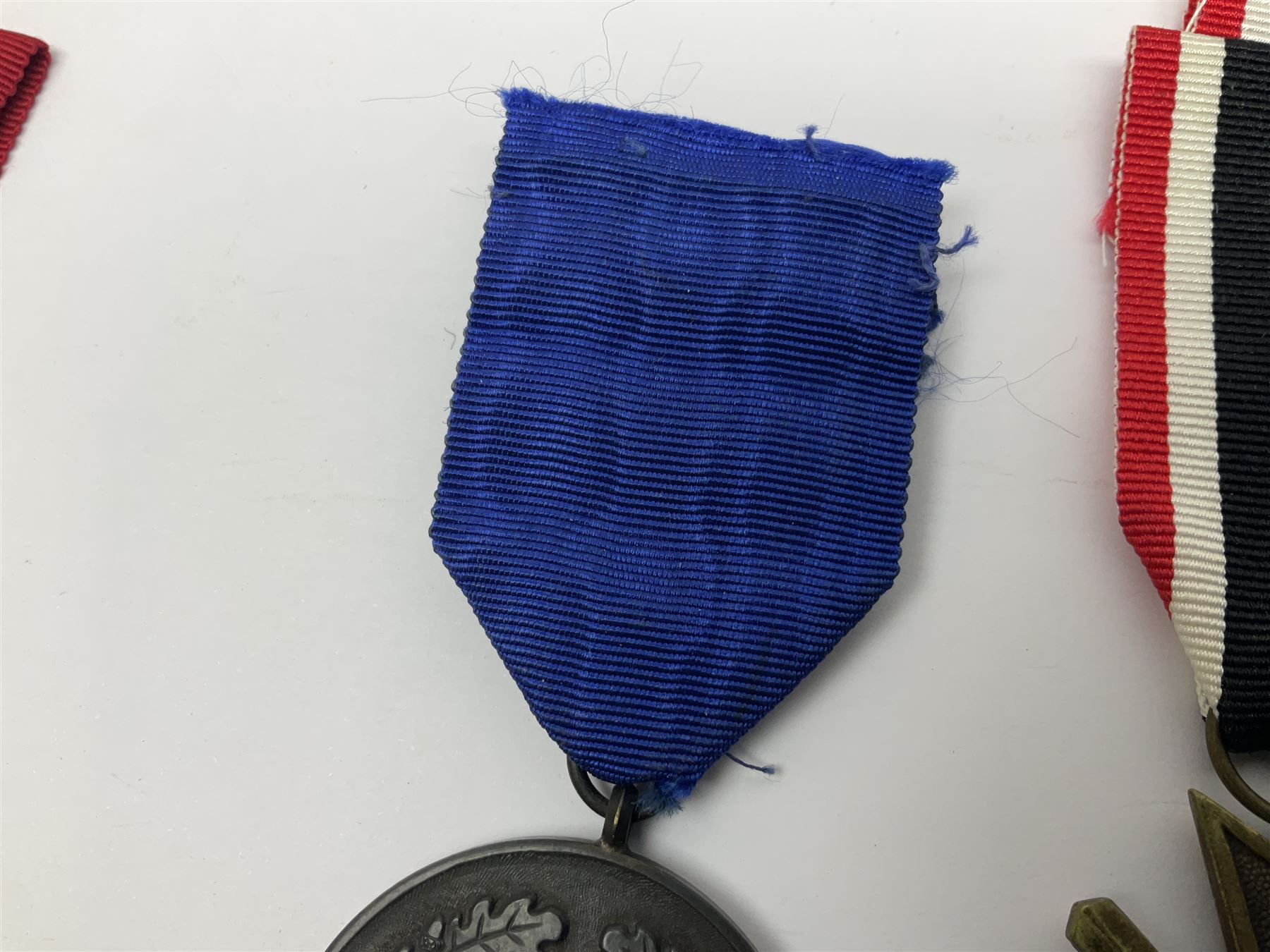 WWII German 'SS' Long Service Medal for four years; Ostfront Medal for the Winter Campaign in Russia of 1941-1942 'Die Medaille Winterschlacht Im Osten'; and War Merit Cross 2nd Class with swords; all with ribbons (3)