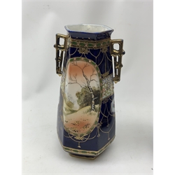A pair of Japanese Nippon Kinjo vases, of tapering hexagonal form with twin stylised handles, the cobalt blue ground with oval hand painted panels to front and verso depicting landscapes, further detailed with smaller floral bands and panels and heightened with gilt, each with mark beneath, H30.5cm.  
