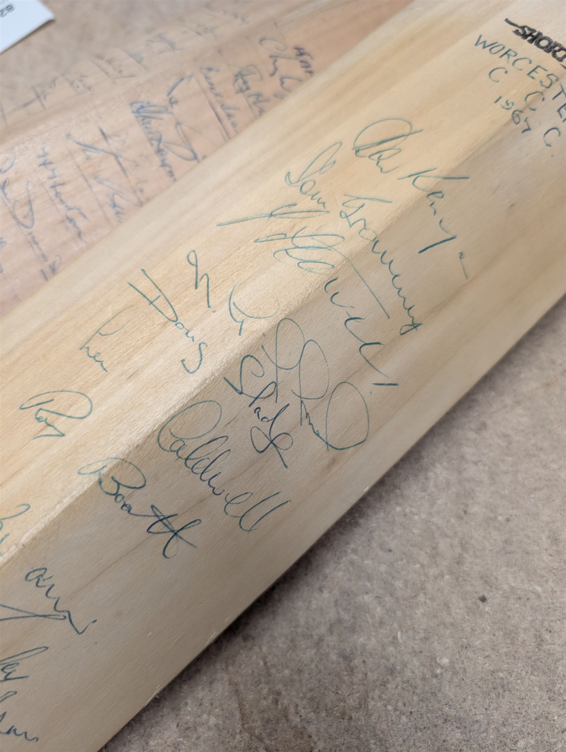 Two signed cricket bats, with signatures including Colin Cowdrey