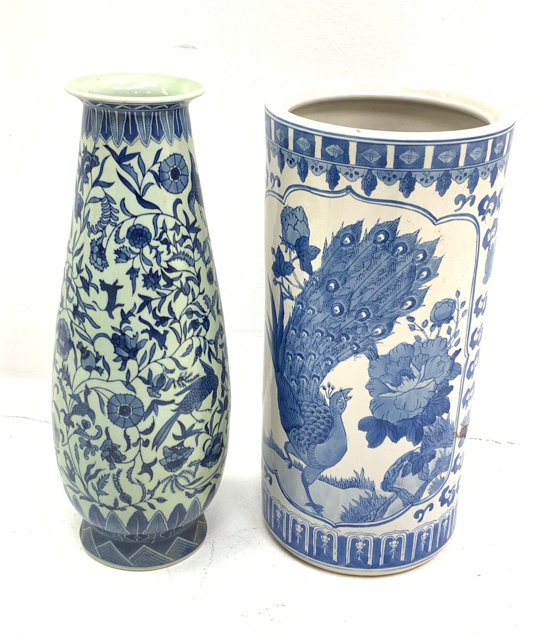 A Chinese blue and white umbrella stand, of cylindrical form decorated with birds perched upon