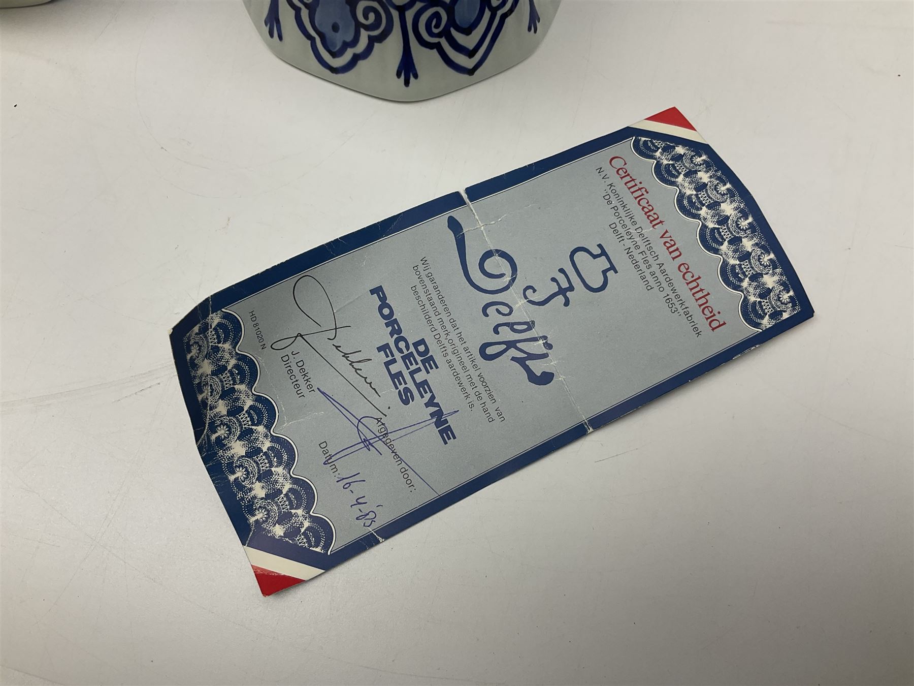 De Porceleyne Fles Delftware blue and white covered jar, of fluted baluster form, with floral and insect decoration, upon an octagonal foot, the octagonal cover with urn shaped finial, H32cm