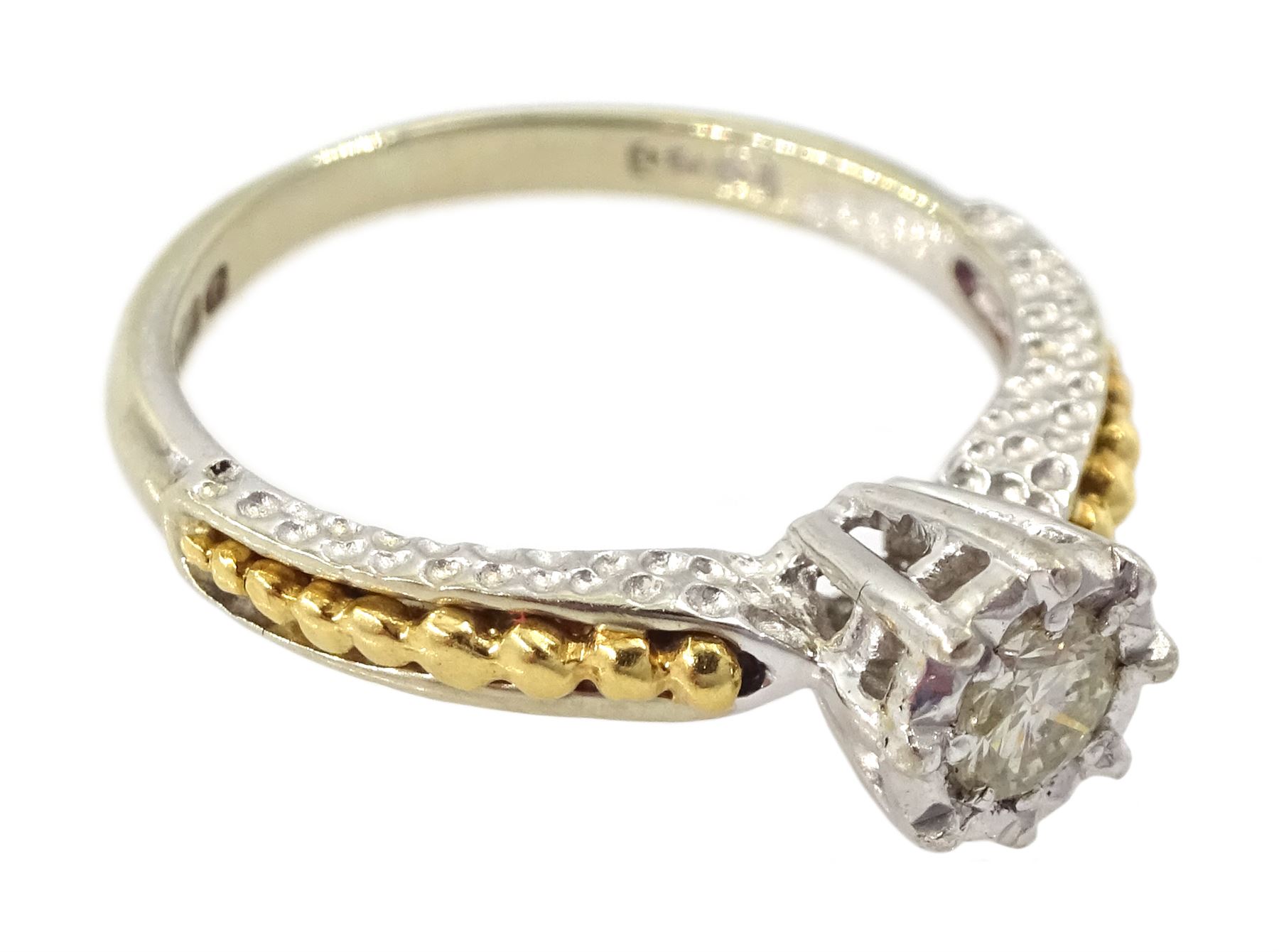 18ct white gold single stone diamond ring, with yellow gold bead design shoulders, London 1979, diamond approx 0.15 carat