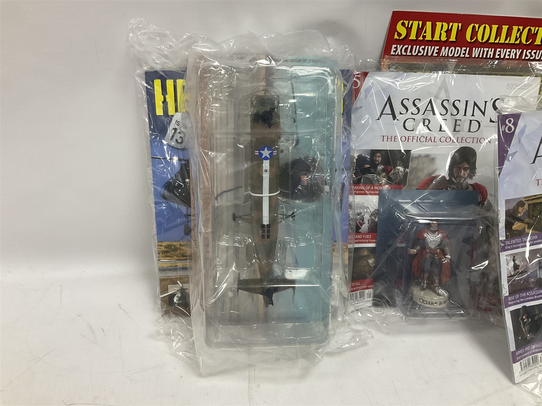 Fifteen Amer Czechoslovakia periodical issued metal models of helicopters each in unopened original packaging with copy of 'Helicopter Magazine'; together with seven unopened Hachette 'Assassin's Creed' periodical figures with magazines (22)