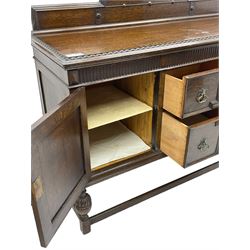 Early 20th century oak sideboard, raised stepped arch back over moulded rectangular top, fitted with two drawers and two panelled cupboards with geometric mouldings, on turned and lobe carved baluster feet united by stretchers 