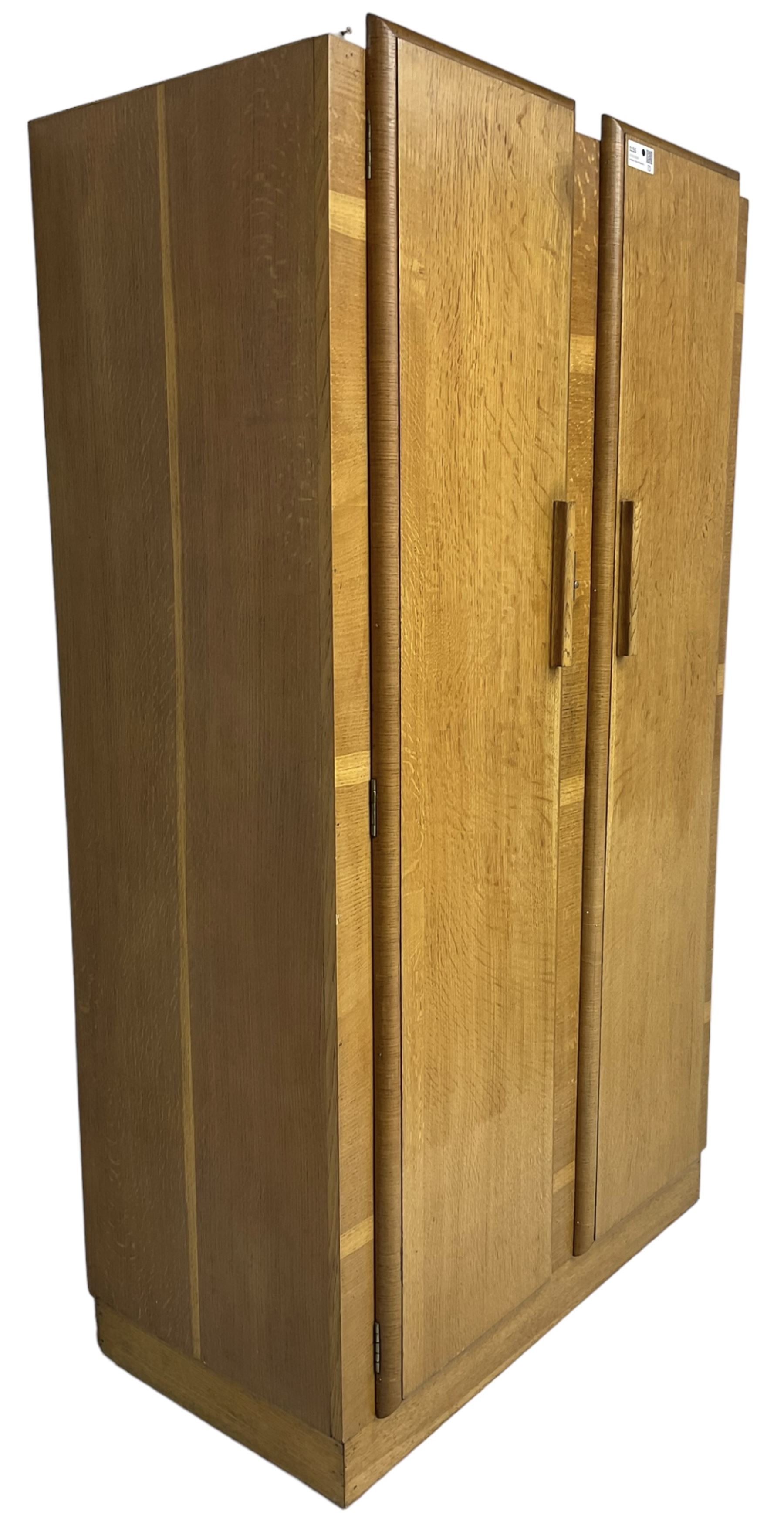 Early 20th century Art Deco period oak Gentleman's wardrobe, the interior fitted with shelves, hanging rails and two long drawers