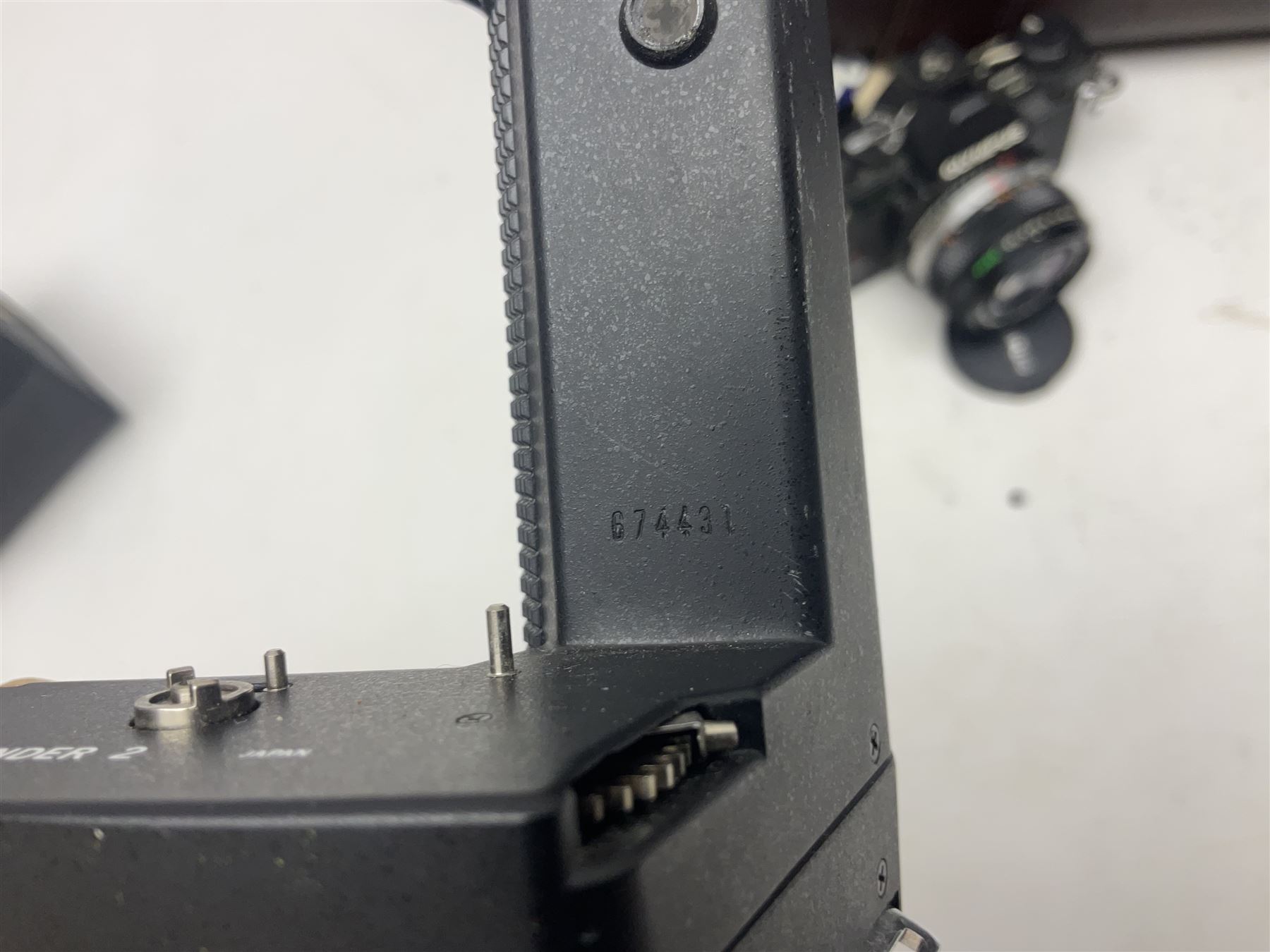 Olympus OM-2 camera body, serial no 1117526, with Olympus OM-System Zuiko Auto-W 28mm 1:2.8'  lens serial no 336591, Olympus OM10 camera body serial no 2392257, with Olympus OM-System Zuiko Auto-Macro 50mm 1:3.5' lens serial no 225784, Soligor C/D mirror lens 1:8 f=500mm' serial no 784035650 together with other camera equipment 