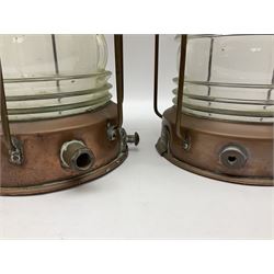Two Ships copper anchor lamps by Meteorite, each with a brass plaque marked with makers name and serial number, and ribbed clear glass shades, H36cm