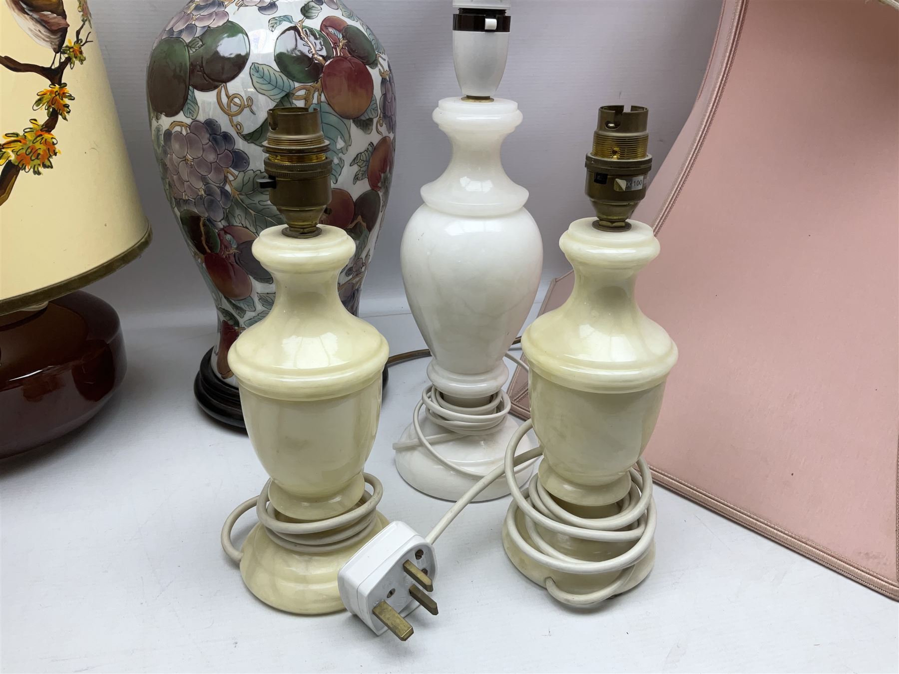 Collection of table lamps to include one of baluster form, decorated with fruit, one of squat, with a hand painted lampshade, and two standard lamps