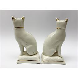 Pair of Victorian Staffordshire cats, modelled seated upon cushions, with gilt detail throughout, H18cm