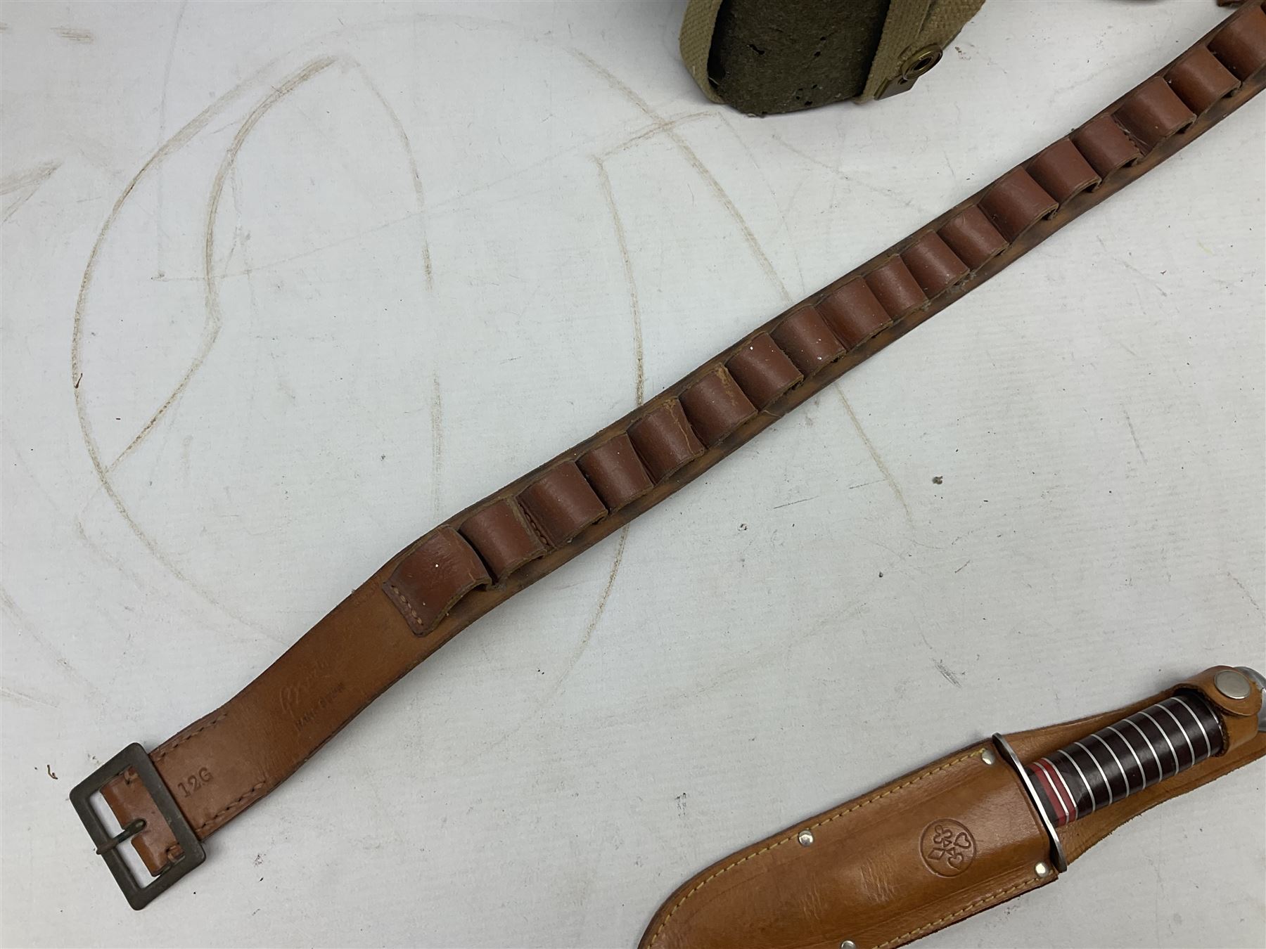 Mundial Brazil bowie knife, the 15.5cm steel blade inscribed 'Sheriff Knife', with banded and aluminium hilt; in leather sheath L29cm overall; British Army felt covered metal water bottle with webbing strap; leather 12-bore cartridge belt; and small pair of non-military binoculars in part case (4)