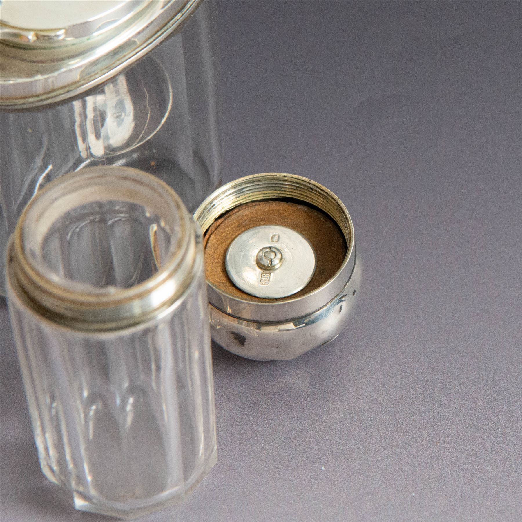 Edwardian tortoiseshell page turner with silver handle, hallmarked Birmingham 1906, maker's mark worn and indistinct, together with a pair of Edwardian silver mounted horsehair brushes engraved with monogram, and two faceted glass jars with silver lids and applied initial N to covers, all hallmarked 