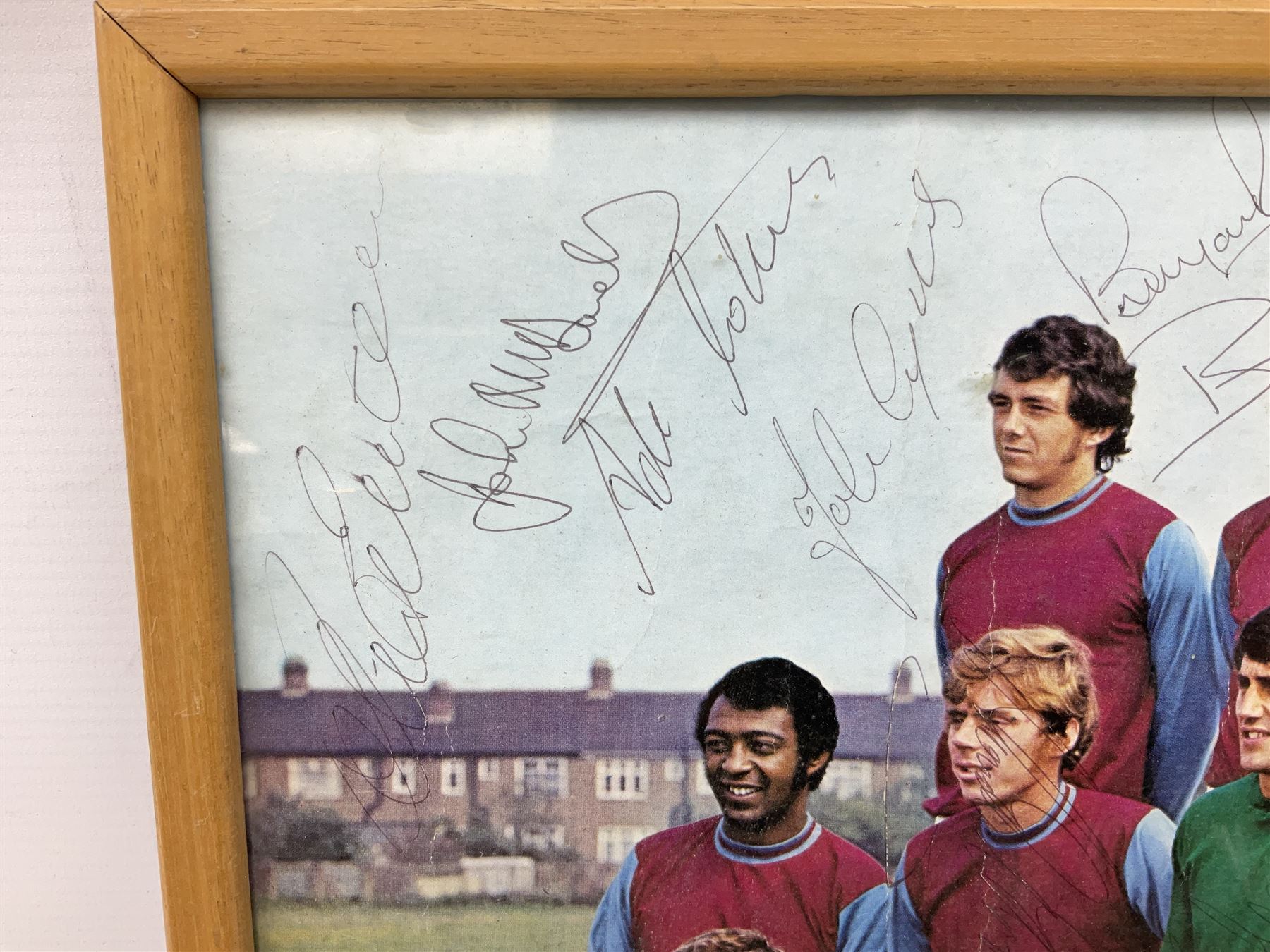 1970-1 photograph of West Ham United FC squad members, including Bobby Moore, Geoff Hurst, Harry Redknapp, Trevor Brooking, Jimmy Greaves, Billy Bonds etc, most players with signatures, 30 x 45cm, framed and glazed