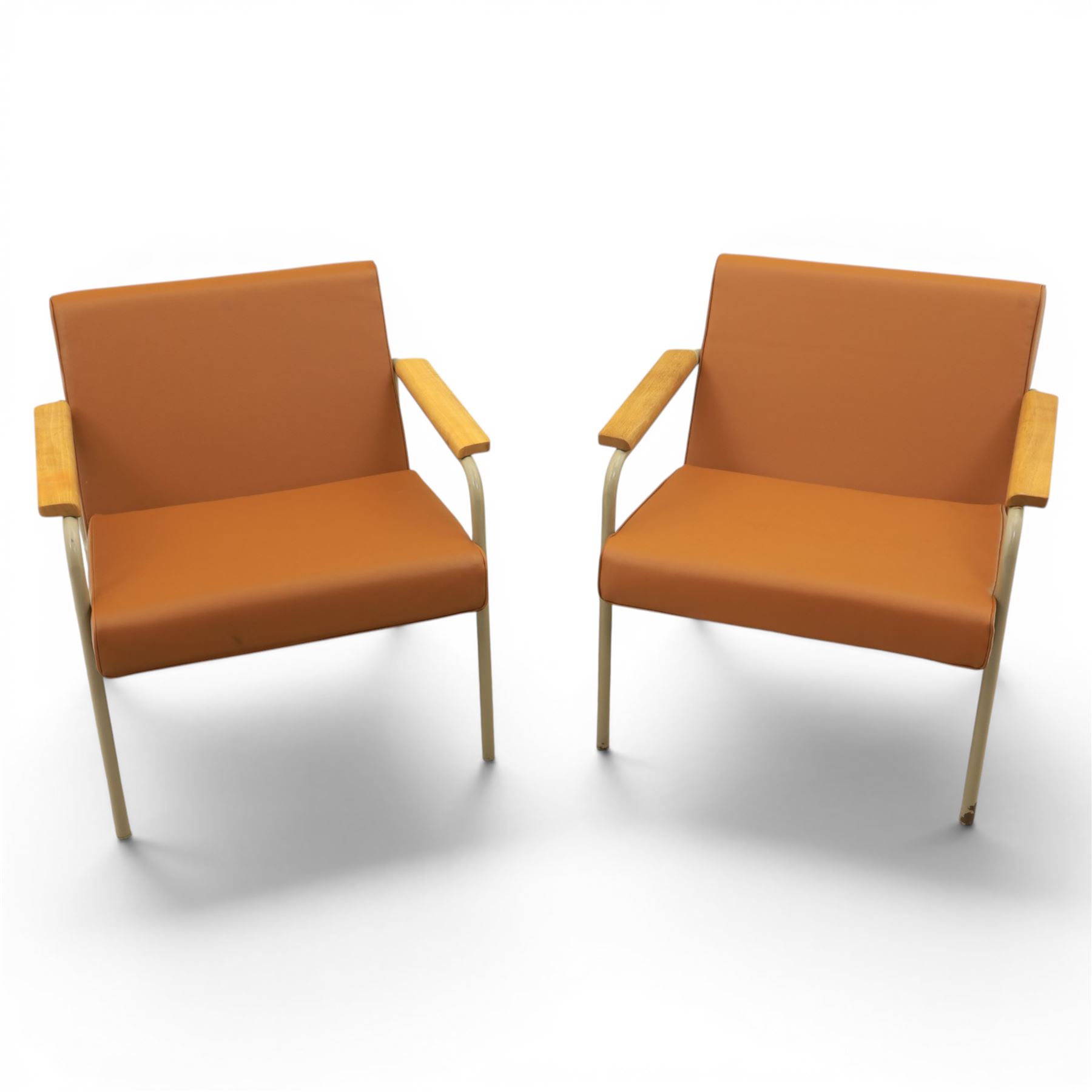 Pair of mid-20th century painted wrought metal easy armchairs with tan leather upholstery and teak armrests