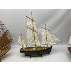 Eight model ships or boats including fishing boat with fish, nets and buoyancy aid, two mast sailing ship complete with cannons, two mast yacht with detailed rigging and life boat etc, the largest L72cm, H60cm