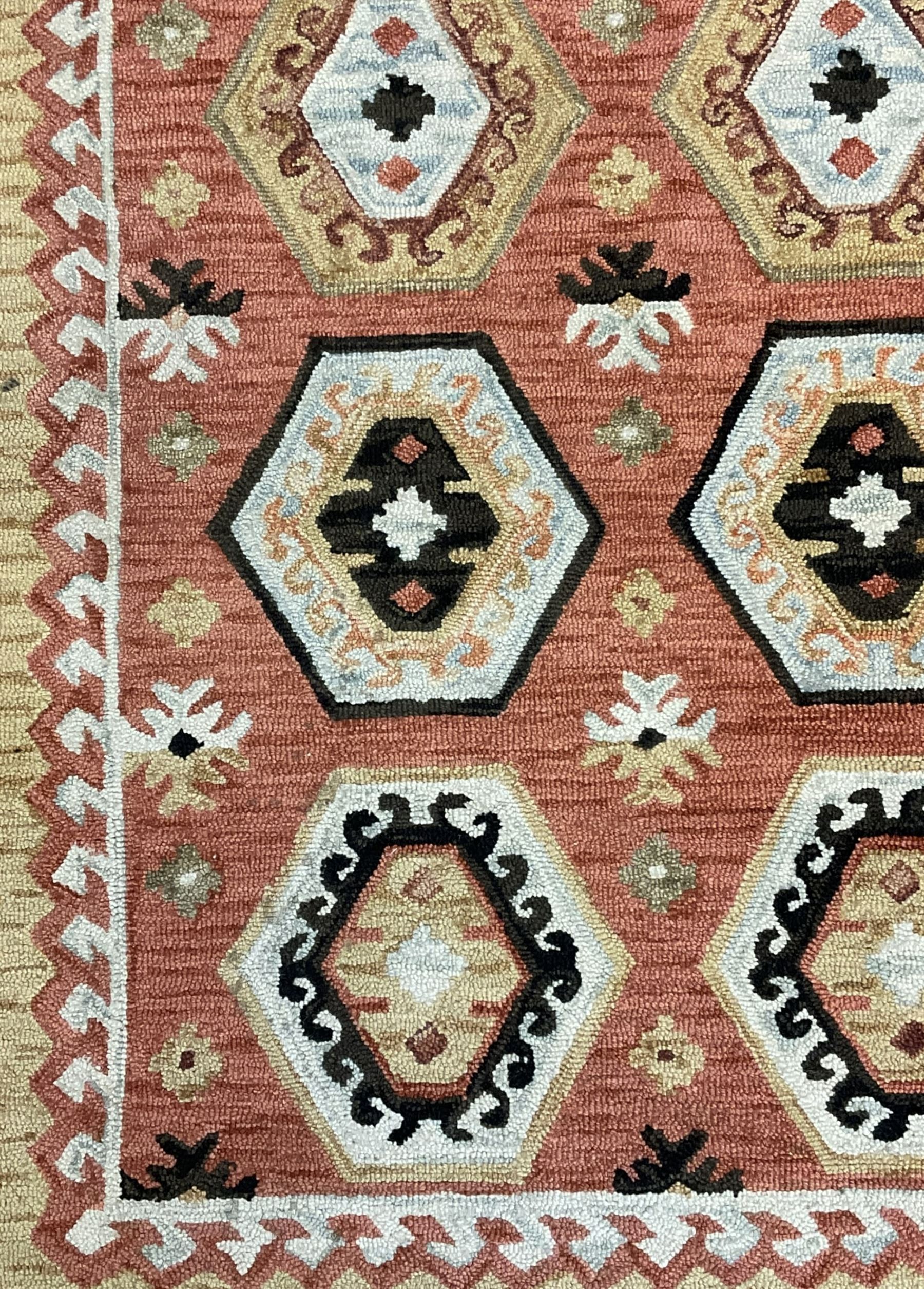 OKA - Turkish design peach ground rug, the field decorated ejder motifs within hooked and geometric design borders 