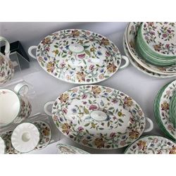 Minton Haddon Hall pattern tea and dinner wares, including basket dish, two covered tureens, six dinner plates, eight dessert plates, twelve tea plates, six soup bowls, six cereal bowls, teapot, coffee pot, milk jug, covered sucrier twelve tea cups and saucers, six mugs, footed bon bon dish, pair of candlestick holders, cake knife and slice etc (81)