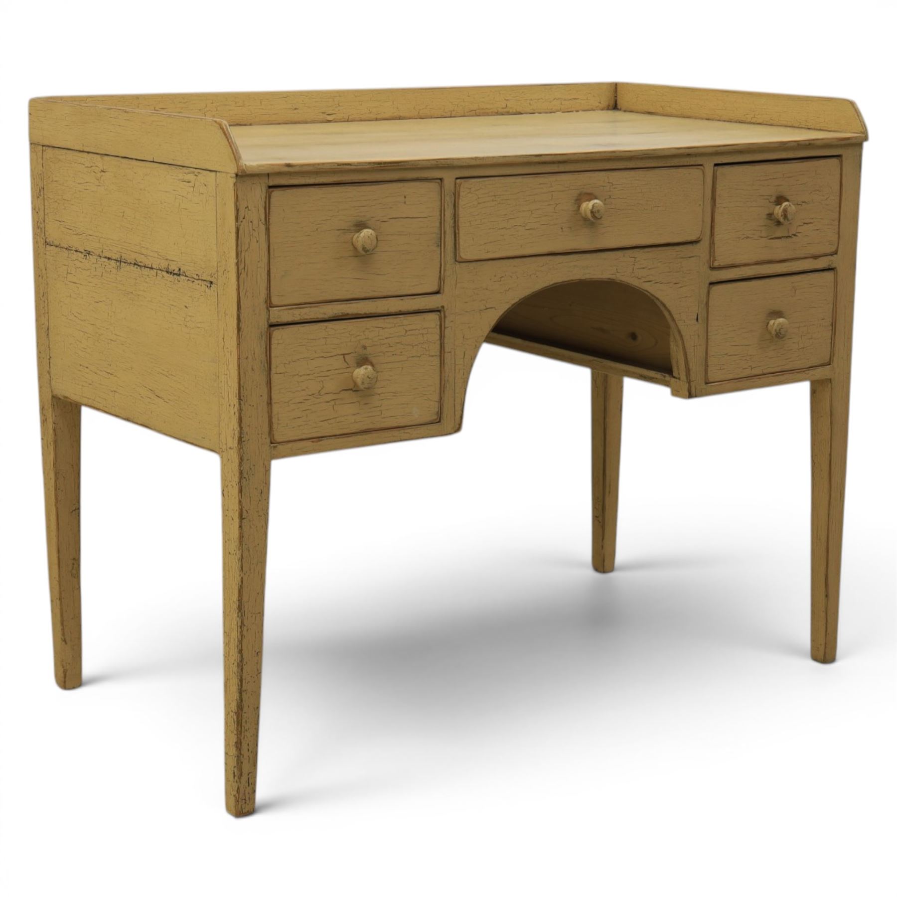 Pine country writing desk, rustic cream paint finish, galleried top over a central drawer flanked by two drawers, tapered square supports