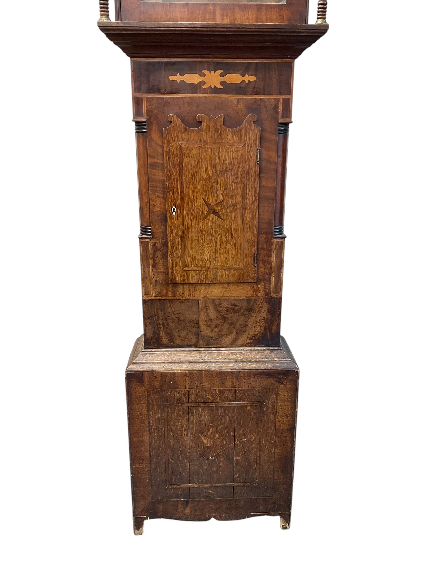 D Hudson of Otley - late 19th century 30 hour oak and mahogany longcase clock, with a swan necked pediment, break arch hood door and ring turned pilasters, inlaid trunk with recessed columns and a short trunk door with inlay and a bone escutcheon, rectangular conforming plinth with a shaped base,  painted dial with geometric spandrels and a depiction of  Britannia to the arch, broad Roman numerals, makers name and calendar dial, dial pinned directly to a chain driven countwheel striking movement, striking the hours on a bell. with pendulum. No weight or movement seat board.