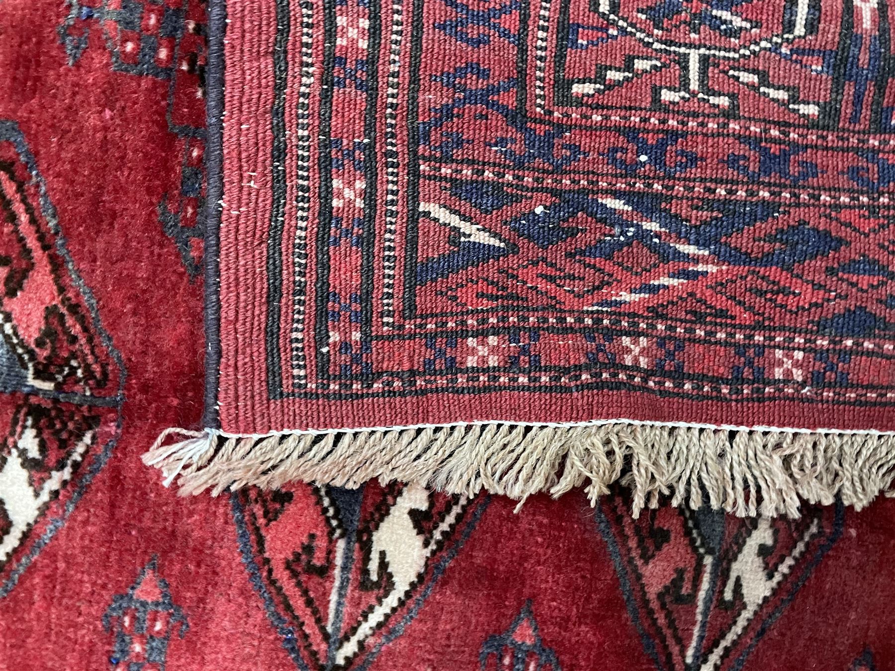 Turkman Bokhara rug, red ground field decorated with repeating Gul motifs