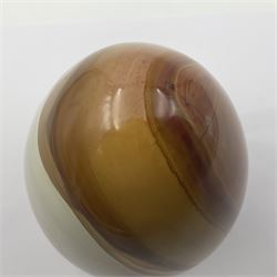 Polychrome jasper specimen egg, in creams, browns and earthy tones, upon a wooden stand, H12cm