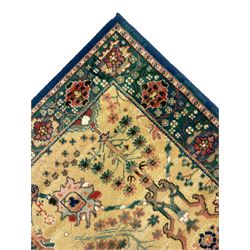 Persian design rug, pale gold ground field decorated with trailing branch and stylised floral motifs, the border decorated with flower heads