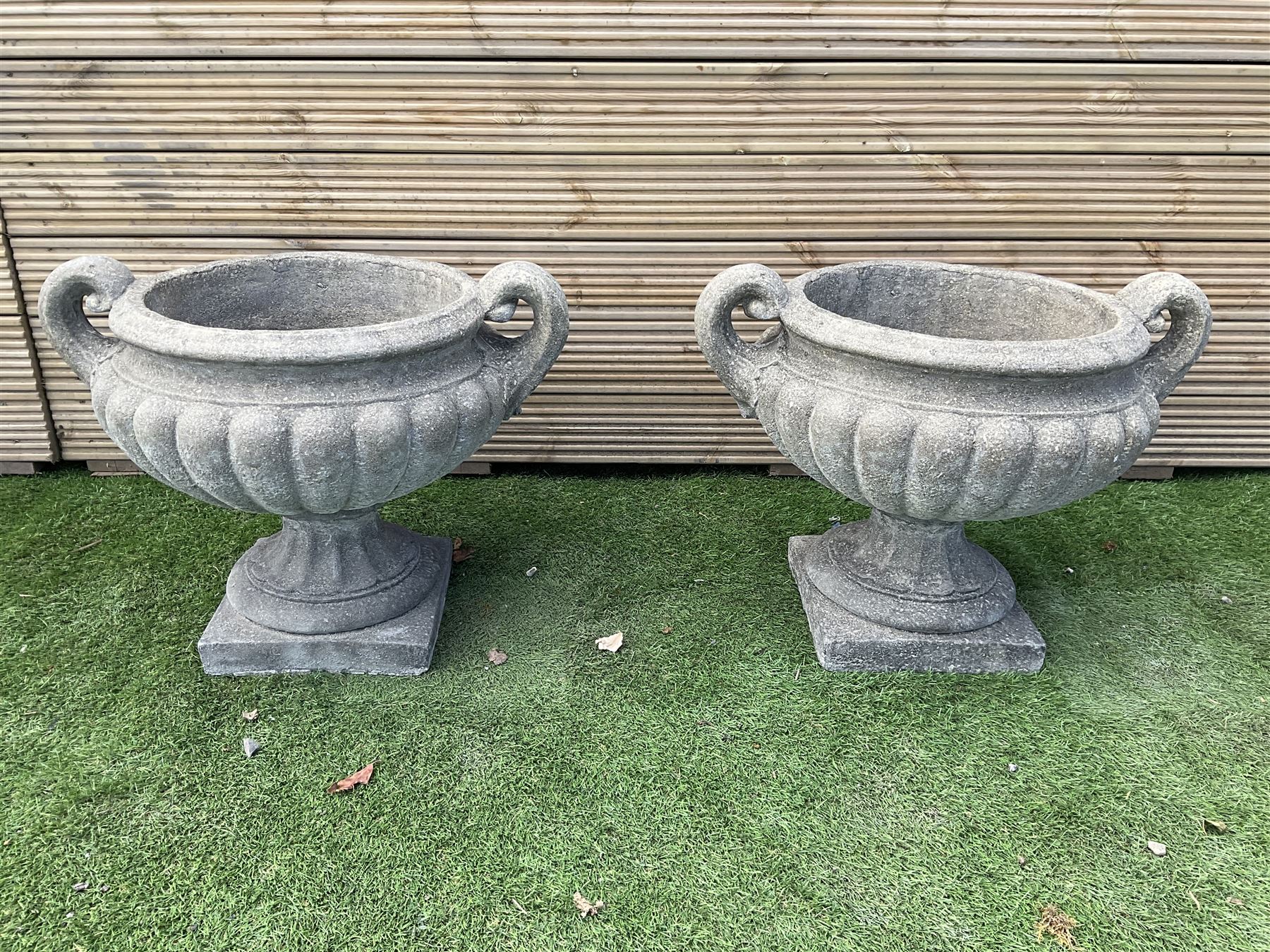 Pair of squat cast stone garden urns, with handles on pedestal  base, D50, H45 - THIS LOT IS TO BE COLLECTED BY APPOINTMENT FROM DUGGLEBY STORAGE, GREAT HILL, EASTFIELD, SCARBOROUGH, YO11 3TX